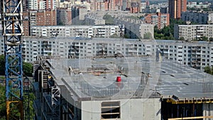 Worker Surveyor Engineer measuring distances elevations and directions on construction site by theodolite level