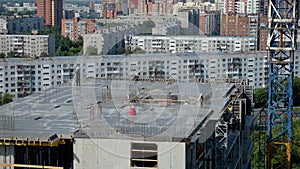 Worker Surveyor Engineer measuring distances elevations and directions on construction site by theodolite level