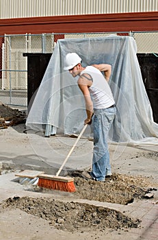 Worker Sweeping Dirt