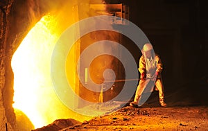 Worker takes a sample at steel company