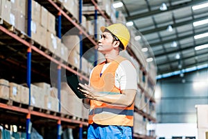 Worker taking inventory in warehouse