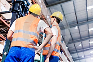 Worker team taking inventory in logistics warehouse