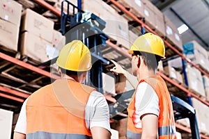 Worker team taking inventory in warehouse