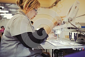 Worker in textile industry sewing