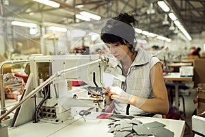 Worker in textile industry sewing