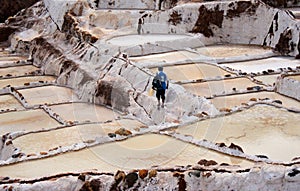 Worker at thef Salinas de Maras is located along the slopes of Qaqawinay mountain,