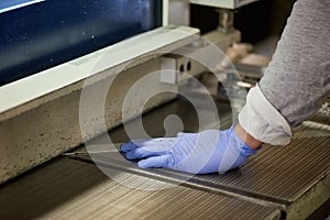 Worker is thrusting a metal sheet.