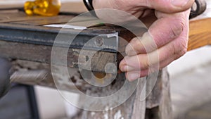 Worker tightening screws in wooden board
