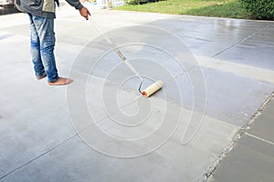 Worker to skim coat surface of concrete pavement floor or slab photo