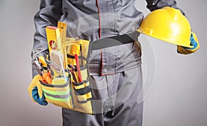 Worker with a tool belt. Construction tools