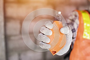 Worker with tool over construction background