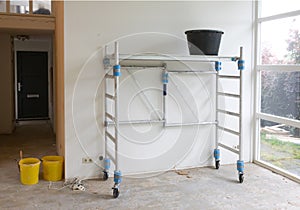 Worker tools - Bucket standing on rolling scaffolding