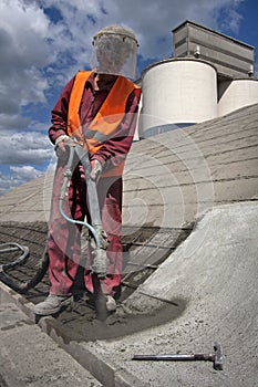 Worker on top of hale is spraying concrete