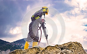 Worker on top of a rock