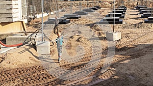 A worker transfers elements for the installation of the formwork at the construction site. Monolithic concrete formwork during the