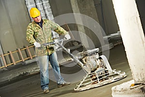 Worker trowelling and finishing of concrete