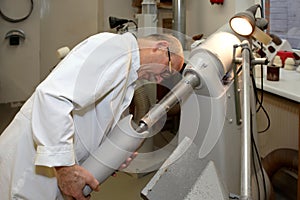 A worker at a tunnel grinding machine.