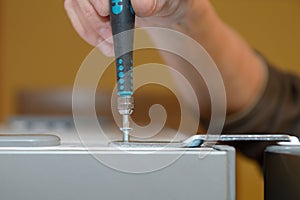 Worker twists the with a screwdriver