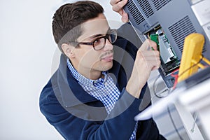 Worker in uniform checking quality processed tool