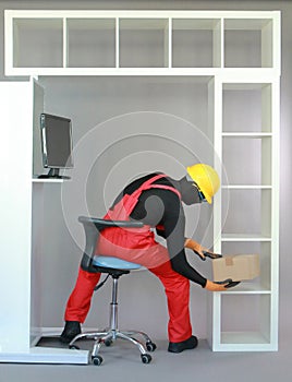 Worker in uniform sitting on stool ,putting  package on the shelf