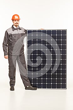 Worker in uniform with solar panels