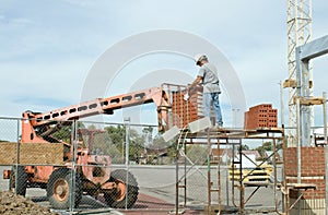 Worker Unloading Brick