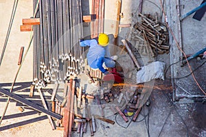 Worker use electric industrial steel cutting machine work in area construction building