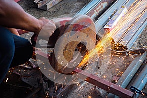 Worker use grinder to cut the tube