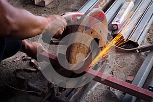 Worker use grinder to cut the tube.