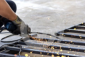 Worker use hand grinder machine grinding the steel pipe .