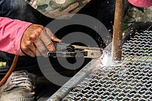 Worker used electric welding wire mesh