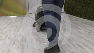 A worker uses a floor cleaning machine.