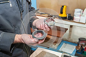 worker uses his hands to make the final polishing of stainless steel parts at a metal products manufacturing plant