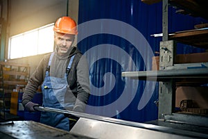 Worker uses modern equipment in a window production