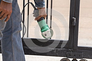 Worker using an angle grinder to grinding door frames