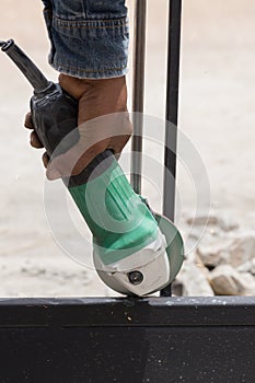 Worker using an angle grinder to grinding door frames