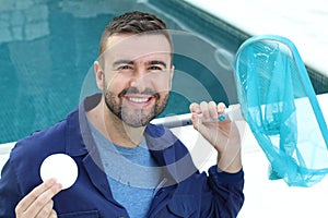 Worker using chlorine in swimming pool photo