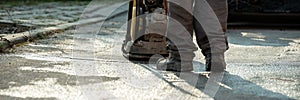 Worker using compactor to finish up patching a bump in the road