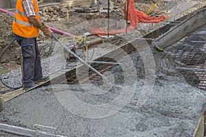 Worker using concrete vibrator