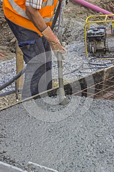 Worker using concrete vibrator 2 photo