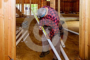 Worker using cutting plastic PVC pipe special scissors in construction