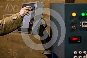 Worker using dashboard of CNC machinery