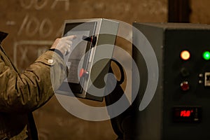 Worker using dashboard of CNC machinery