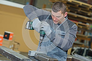 Worker using electric drill
