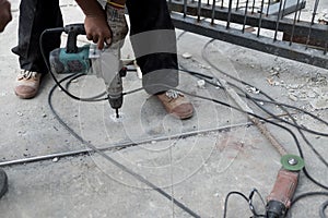 Worker using electric drill ground drilling by machine tool