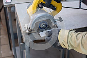 Worker using a grinding machine for cut cement board