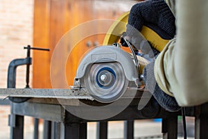 Worker using a grinding machine for cut cement board