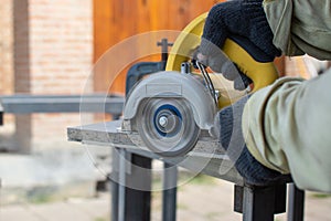 Worker using a grinding machine for cut cement board