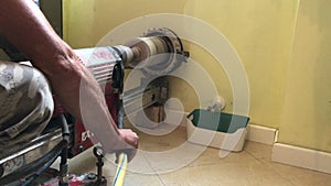Worker using hammer drill during a coring work on the wall