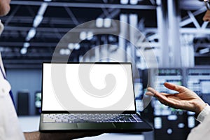 Worker using laptop in data center